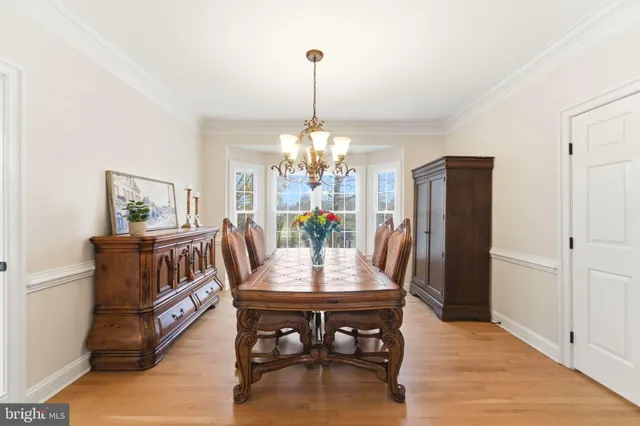 a kitchen with granite countertop white cabinets and a window