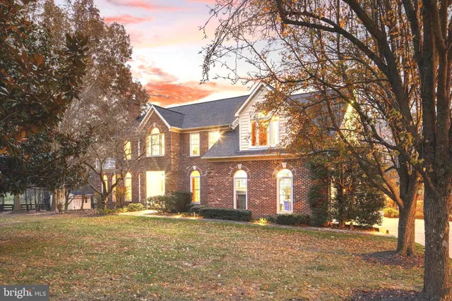 a dining room with furniture a chandelier and wooden floor