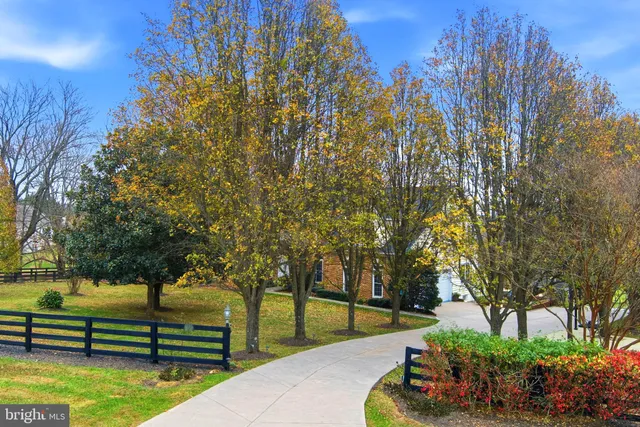 a large kitchen with a large window a sink stainless steel appliances and cabinets