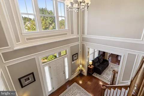 a living room with furniture a dining table and chairs with wooden floor