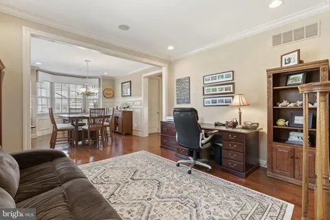 a view of a livingroom with workspace and a window