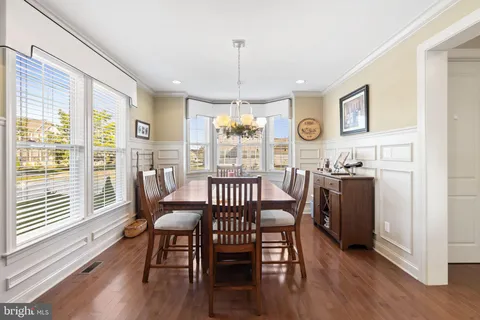 a kitchen with a sink stove and wooden floor