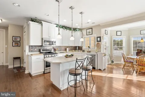a view of a dining room with furniture wooden floor and a chandelier