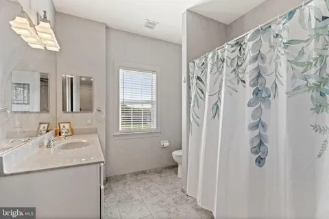 a view of a swimming pool with a yard and a large tree