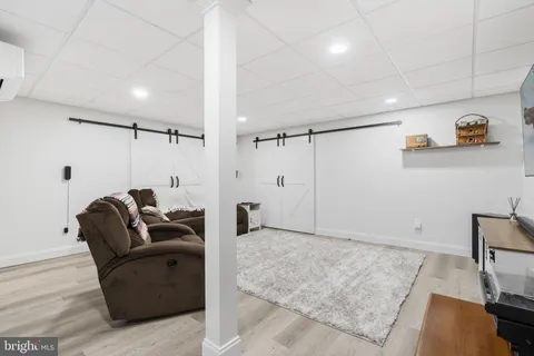 a view of a house with a big yard and large trees