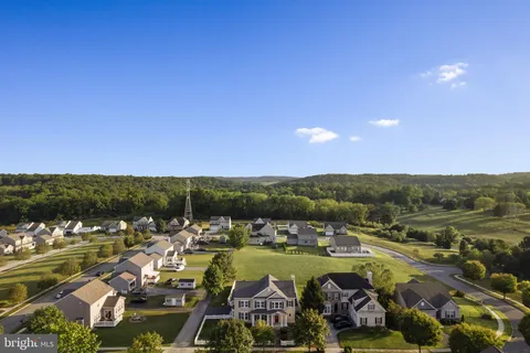 an aerial view of residential houses with outdoor space and river