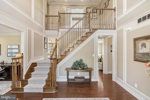 a living room with furniture rug and wooden floor