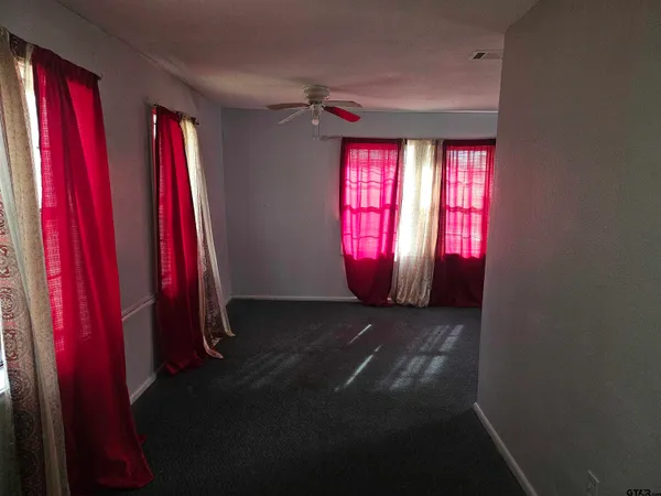a view of a hallway with red walls and a window