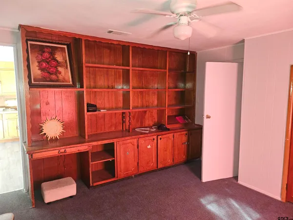 an empty room with cabinet and window