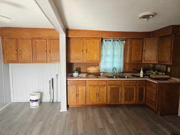 a kitchen with stainless steel appliances a sink a stove a refrigerator and cabinets