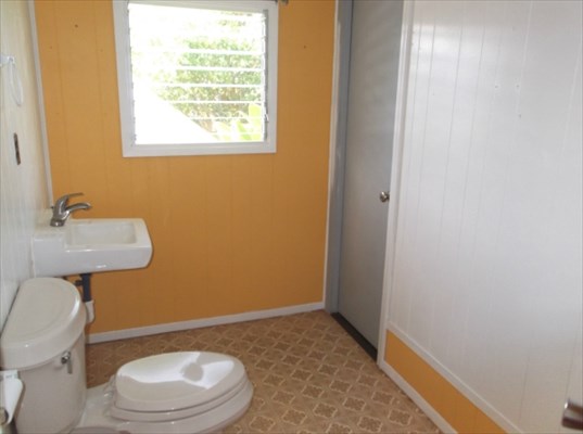 4971 Ea Road Kapaa, HI 96746 - Photo 14 of 25 a bathroom with a toilet a sink and mirror
