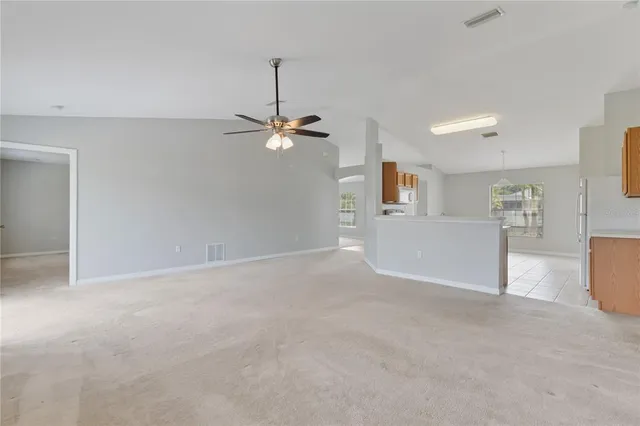 a view of a big room with windows and chandelier