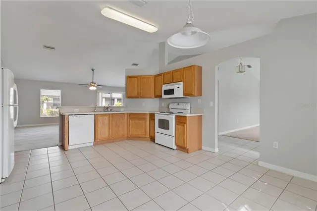 a kitchen with stainless steel appliances a refrigerator sink and microwave