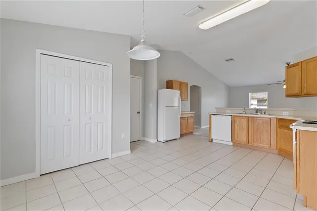 a view of kitchen with a sink cabinets and window