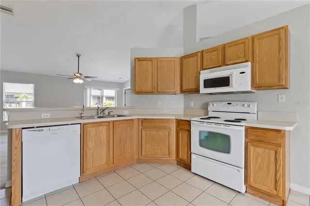 a kitchen with granite countertop a sink stainless steel appliances and cabinets