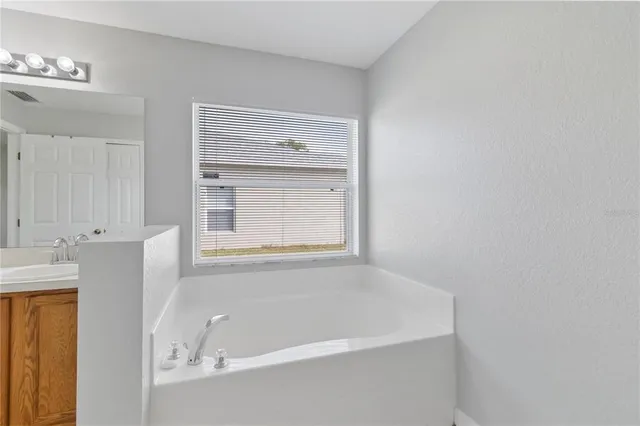 a white bath tub sitting next to a window