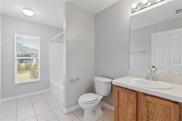 a bathroom with a sink toilet and vanity