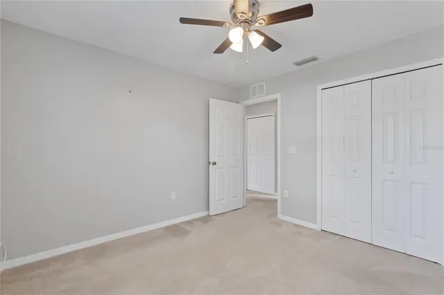 an empty room with a empty space and a ceiling fan