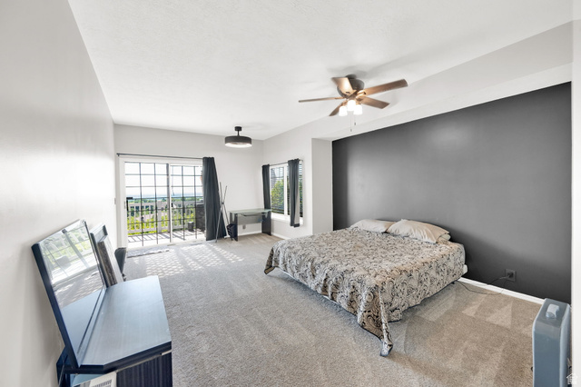 5057 South Ridgedale Drive Ogden, UT 84403 - Photo 18 of 69 Spacious carpeted room featuring a large sliding glass door, an additional window, and a ceiling fan