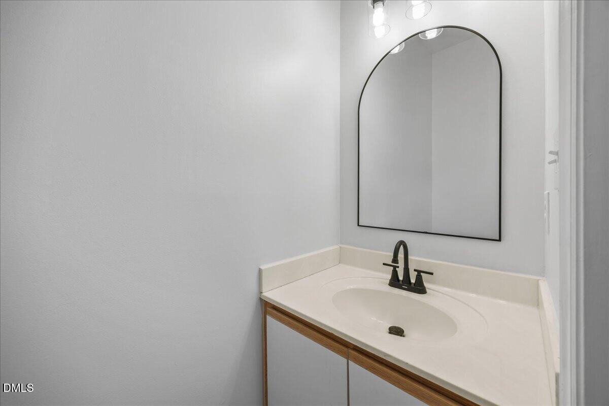 3831 Pin Oak Road Raleigh, NC 27604 - Photo 11 of 24 a bathroom with a sink and a mirror