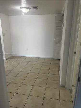 a view of an empty room and a window