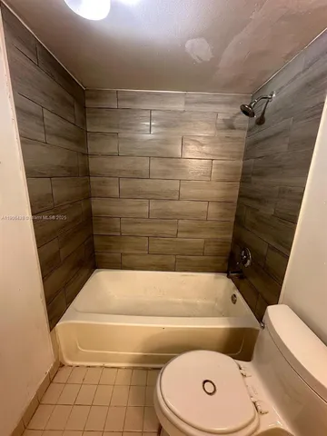 a bathroom with a toilet and shower