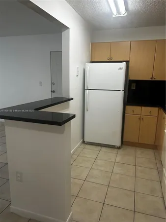 a utility room with cabinets washer and dryer