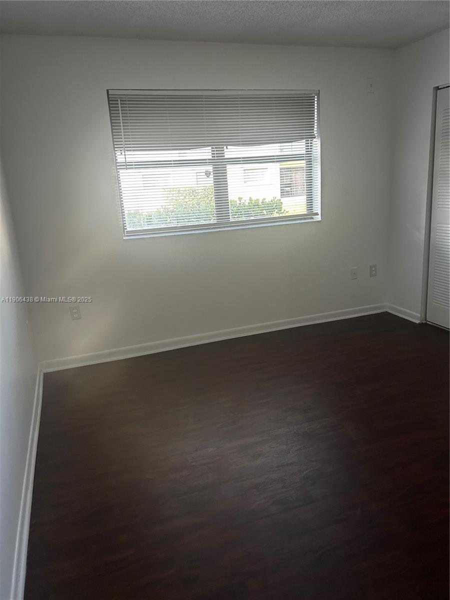 7110 Northwest 179th Street, Unit 110 Hialeah, FL 33015 - Photo 10 of 13 an empty room with a window