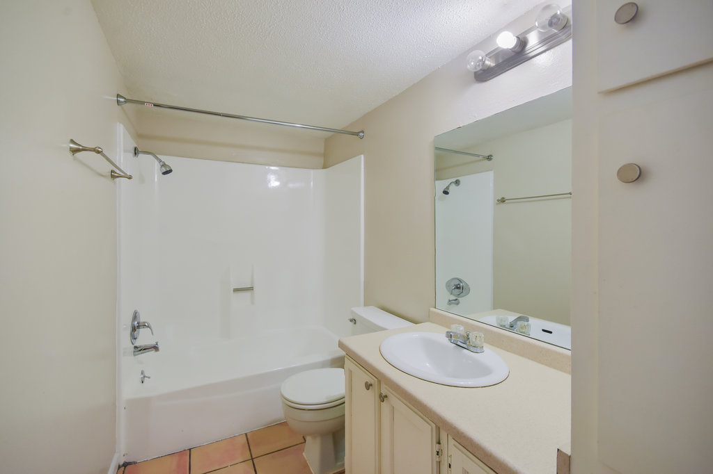 1000 West 26th Street, Unit 102 Austin, TX 78705 - Photo 17 of 23 a bathroom with a sink toilet granite vanity and shower