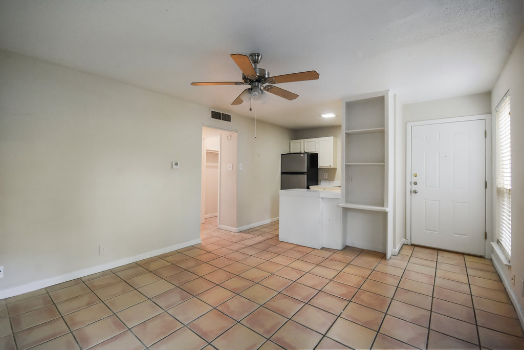 1000 West 26th Street, Unit 102 Austin, TX 78705 - Photo 8 of 23 a view of a kitchen with a refrigerator and a stove top oven