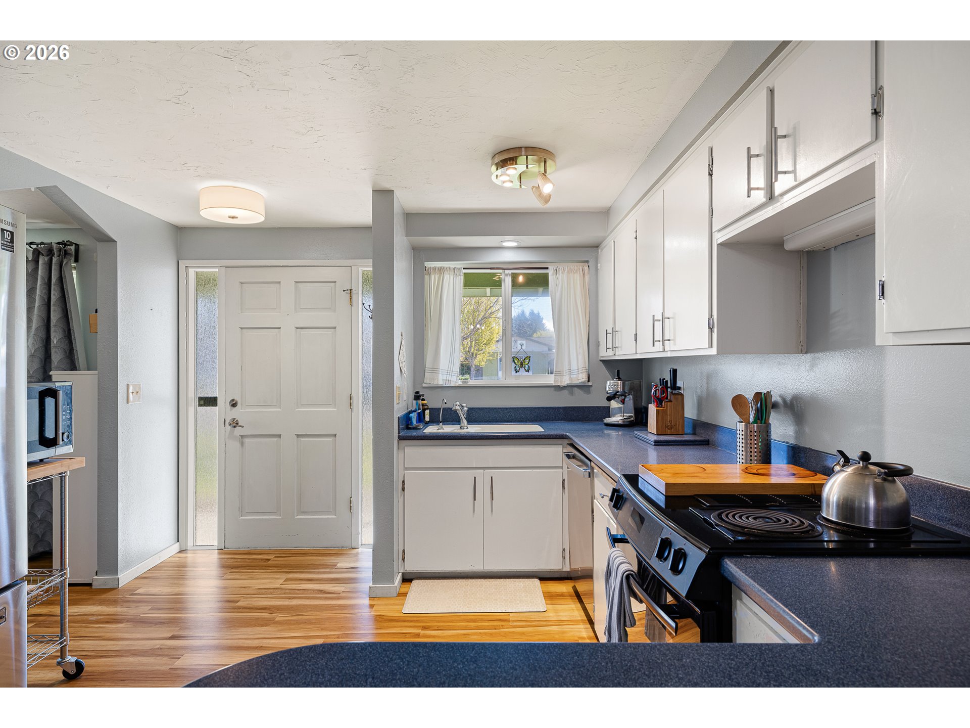 992 Candlelight Drive Eugene, OR 97402 - Photo 11 of 35 a kitchen with stainless steel appliances a stove a sink and a refrigerator