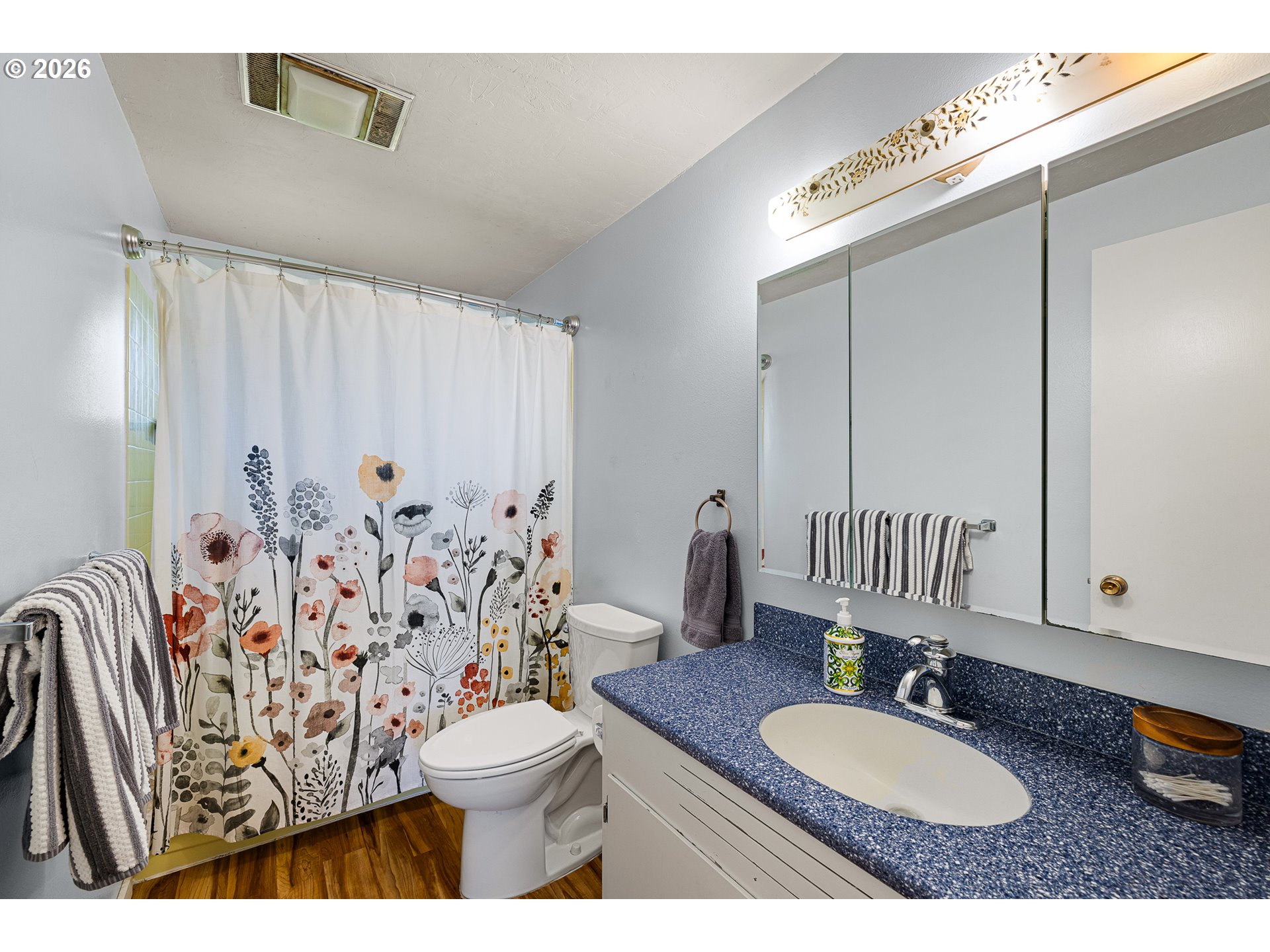 992 Candlelight Drive Eugene, OR 97402 - Photo 20 of 35 a bathroom with a granite countertop sink a toilet and a mirror