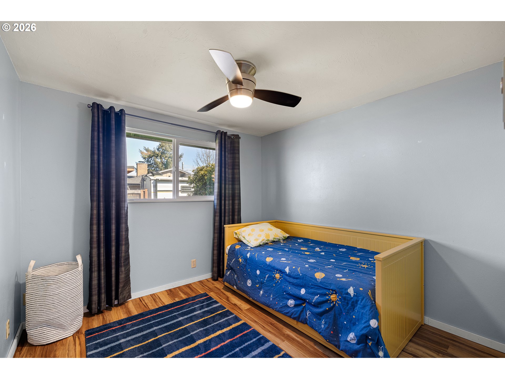 992 Candlelight Drive Eugene, OR 97402 - Photo 21 of 35 a bedroom with wooden floor and a ceiling fan