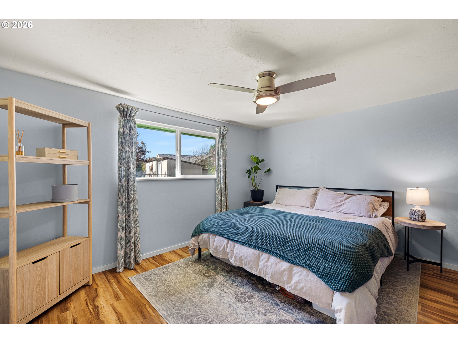 992 Candlelight Drive Eugene, OR 97402 - Photo 23 of 35 a bedroom with a bed a dresser and potted plant