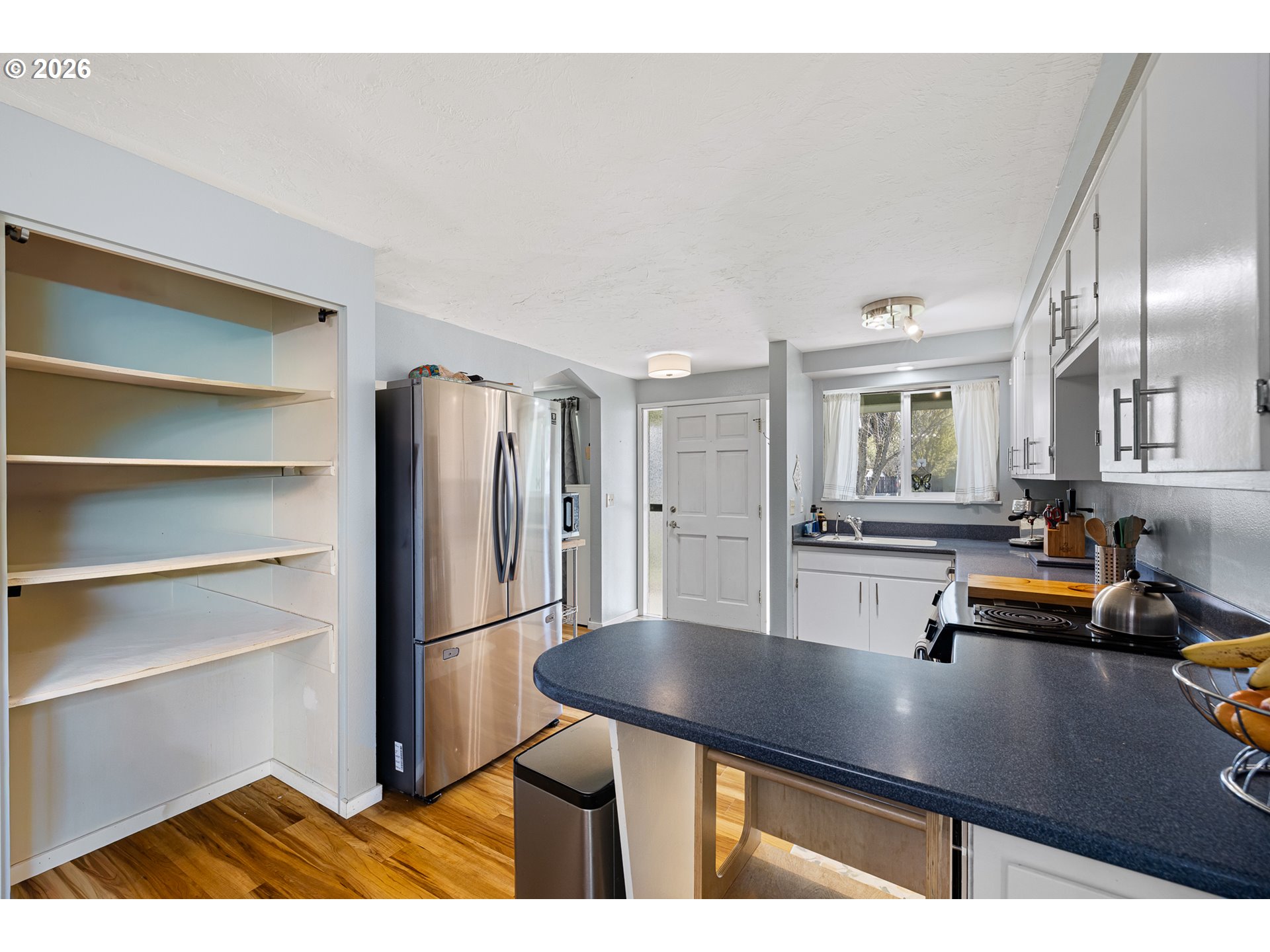 992 Candlelight Drive Eugene, OR 97402 - Photo 6 of 35 a kitchen with refrigerator and window