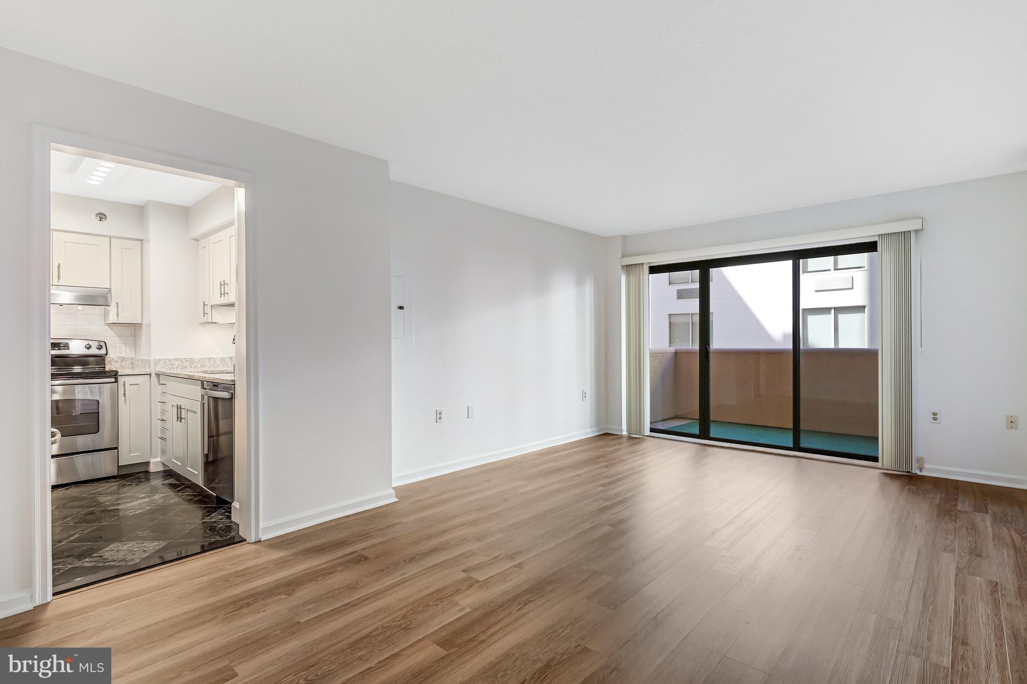 1301 North Courthouse Road, Unit 705 Arlington, VA 22201 - Photo 17 of 38 wooden floor in an empty room with a kitchen