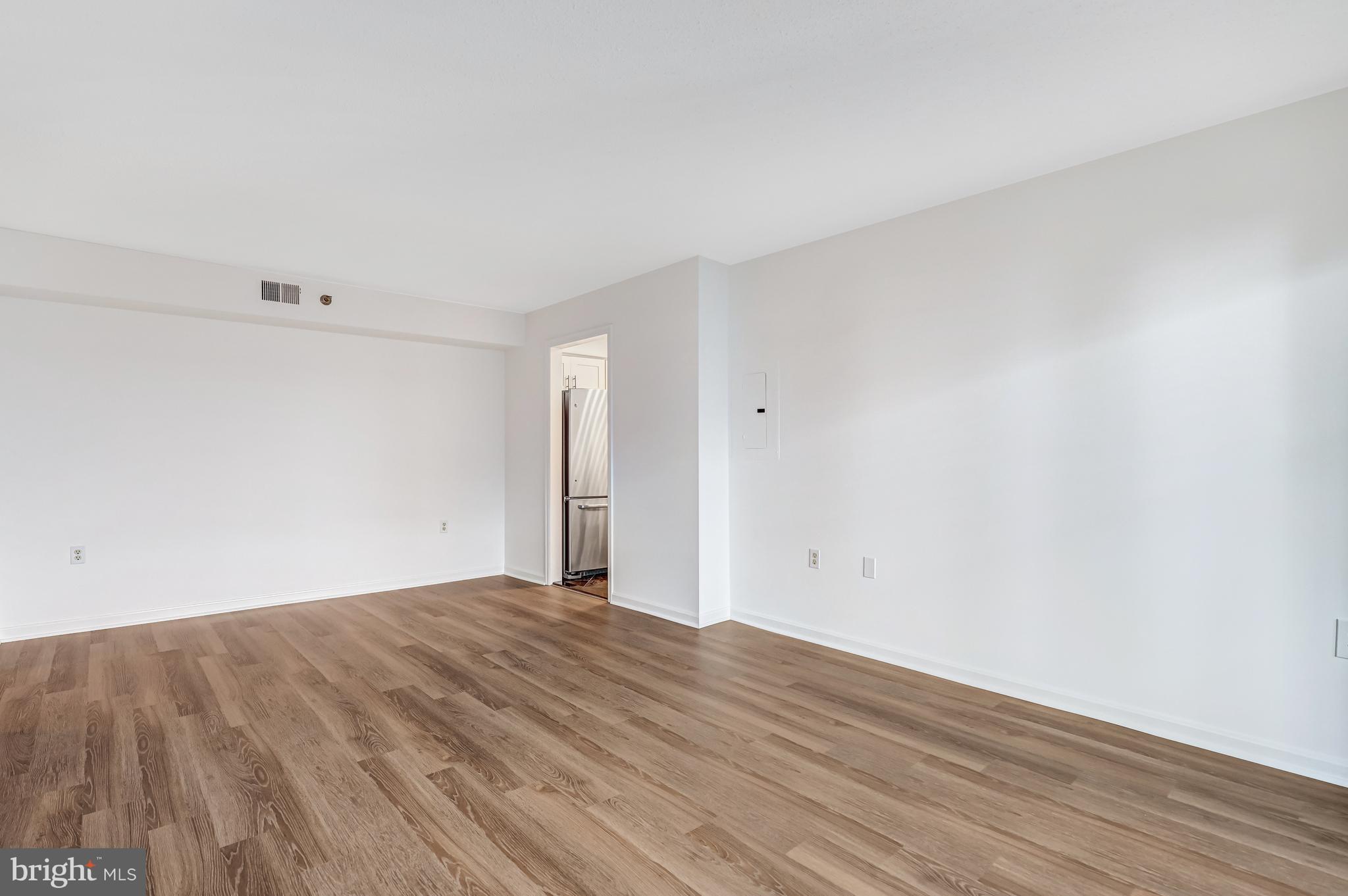 1301 North Courthouse Road, Unit 705 Arlington, VA 22201 - Photo 18 of 38 a view of an empty room with wooden floor
