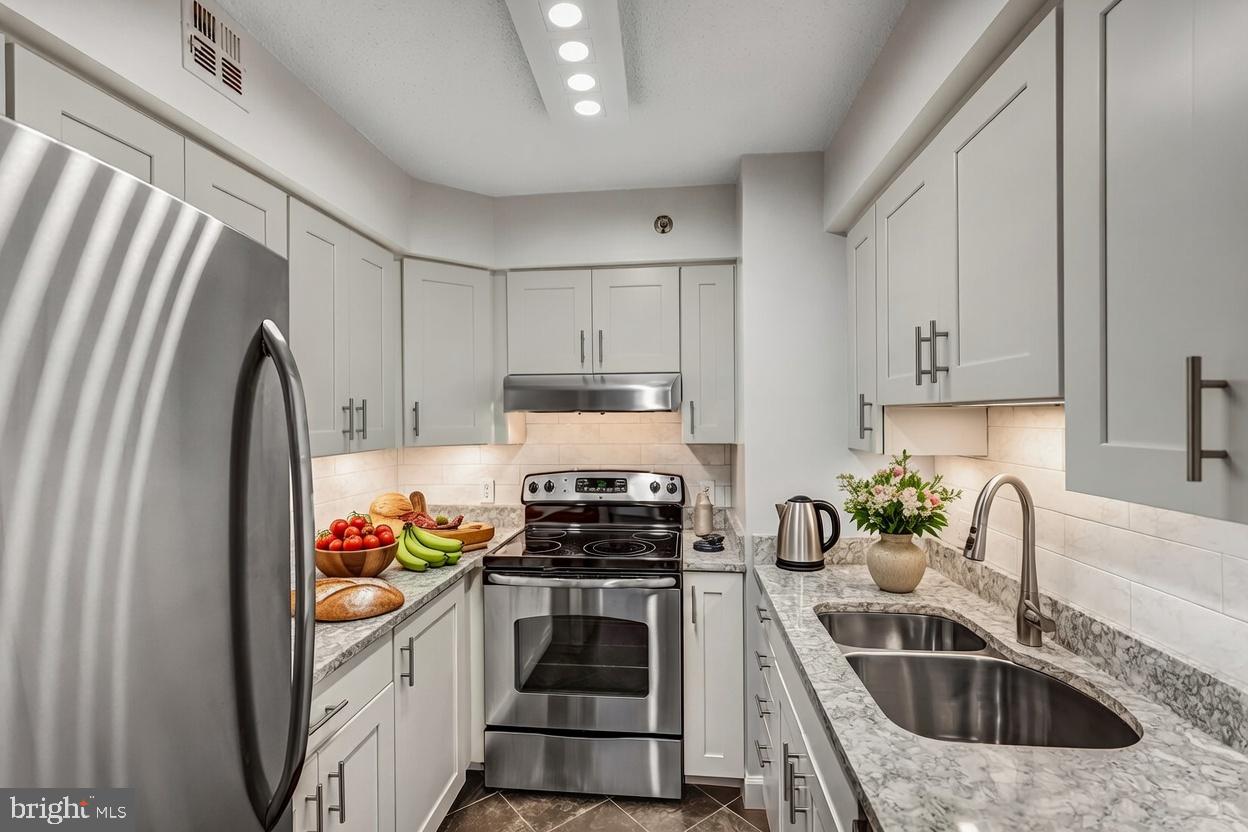 1301 North Courthouse Road, Unit 705 Arlington, VA 22201 - Photo 2 of 38 a kitchen with sink a stove and refrigerator