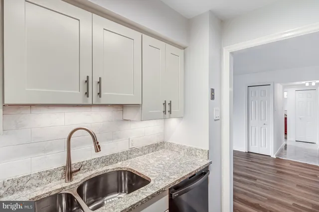 a kitchen with a sink and cabinets