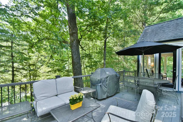an outdoor sitting area with furniture and garden