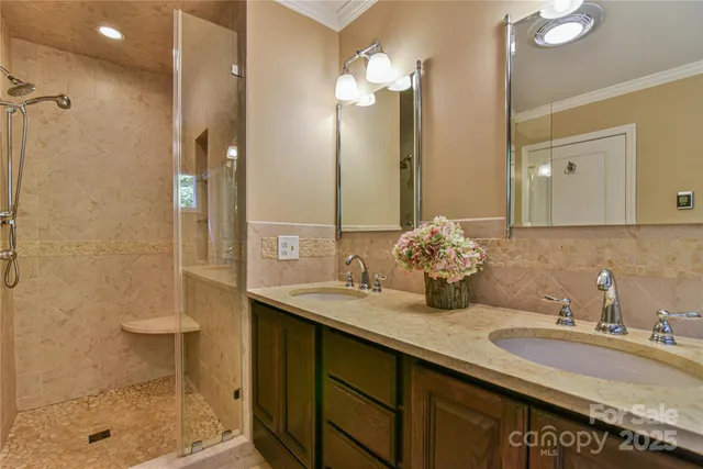 a bathroom with a sink double vanity and shower