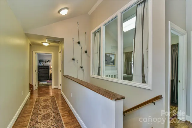 a hallway with a large window and front door