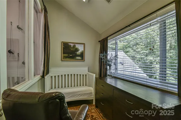 a view of a bedroom with furniture and a window