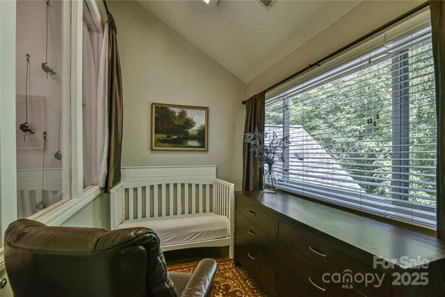 a view of a bedroom with furniture and a window