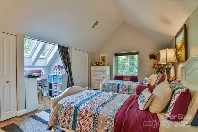 a bed room with a bed window and mirror