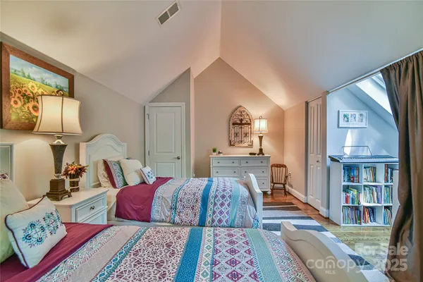 a bed room with a bed and a book shelf