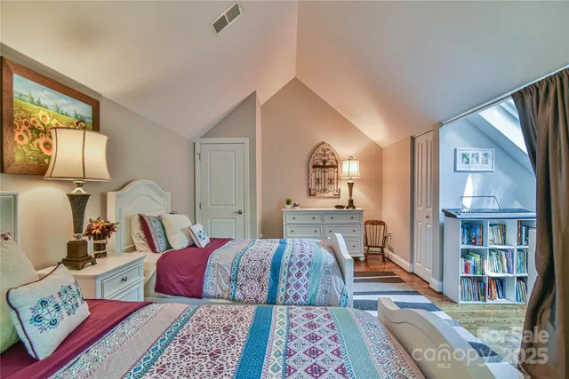 a bed room with a bed and a book shelf