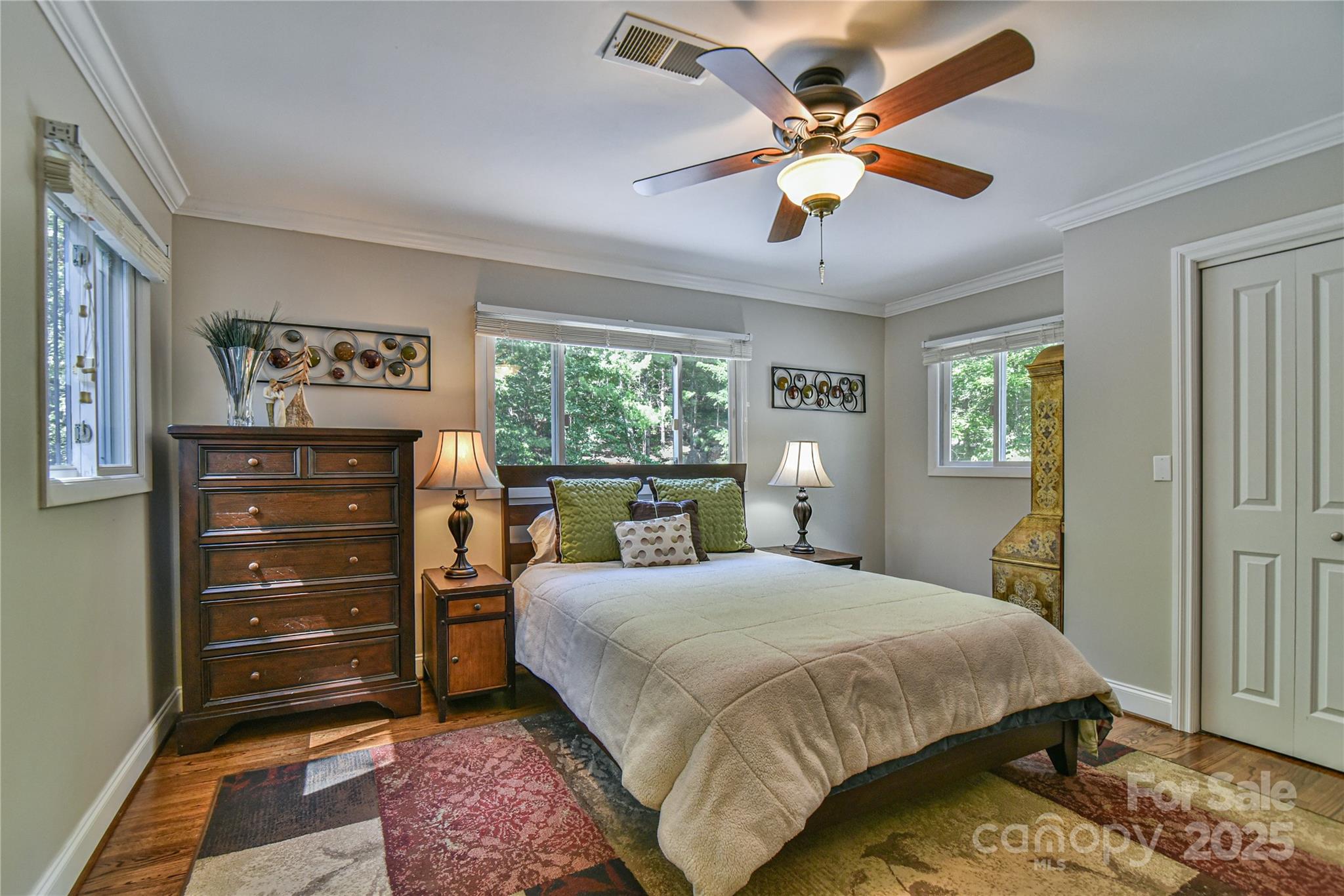 409 North Fork Road Black Mountain, NC 28711 - Photo 31 of 48 a bedroom with a bed and a chandelier