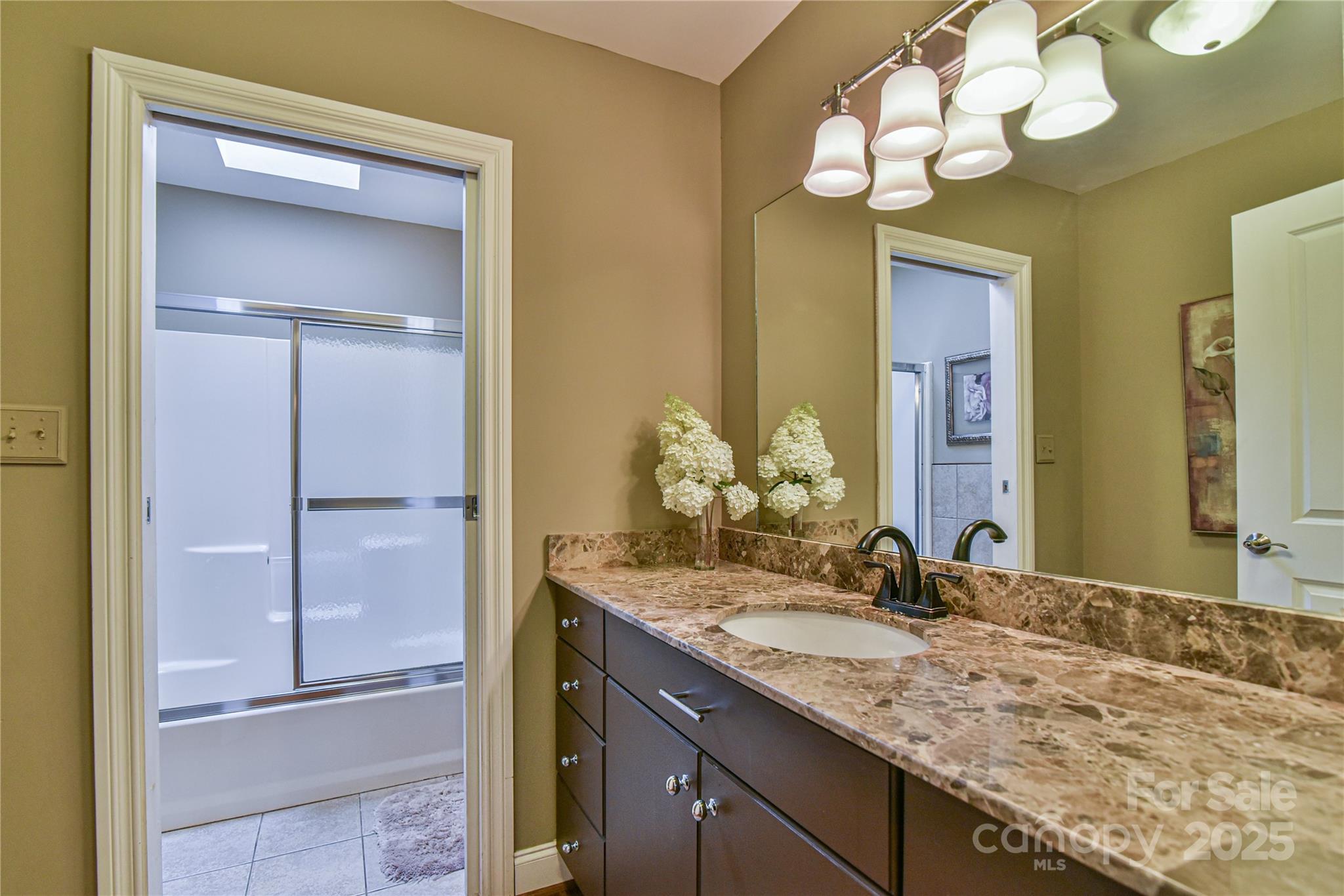 409 North Fork Road Black Mountain, NC 28711 - Photo 32 of 48 a bathroom with a granite countertop sink and a mirror