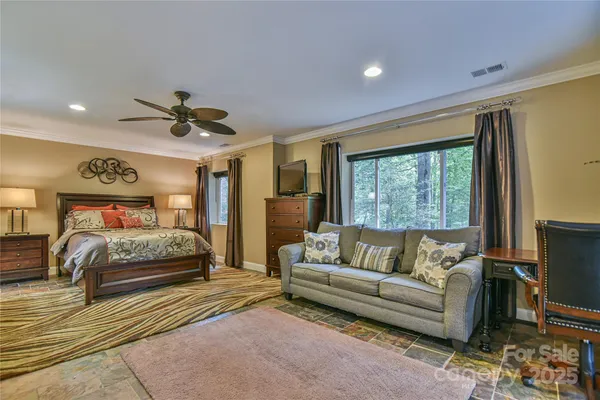 a bedroom with a large bed and a couch